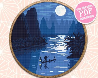 May include: A cross stitch pattern of a moonlit scene with mountains, a river, and a boat with two people in it. The pattern is in a round wooden embroidery hoop. The text "cross stitch pattern PDF instant download" is on a pink circle.