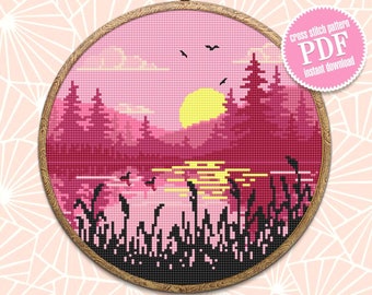 May include: Cross stitch pattern PDF for a pink sunset landscape with a lake, trees, and birds. The pattern is in a circular embroidery hoop.