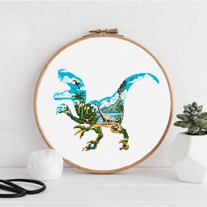 May include: A cross-stitch pattern of a blue dinosaur silhouette with a tropical island scene inside. The dinosaur is facing left and has a long tail. The island scene includes palm trees, a mountain, and a body of water.