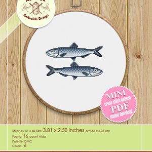 May include: A counted cross stitch pattern of two blue fish on a white background. The pattern is available for instant download as a PDF file. The finished size is 3.81 x 2.50 inches.
