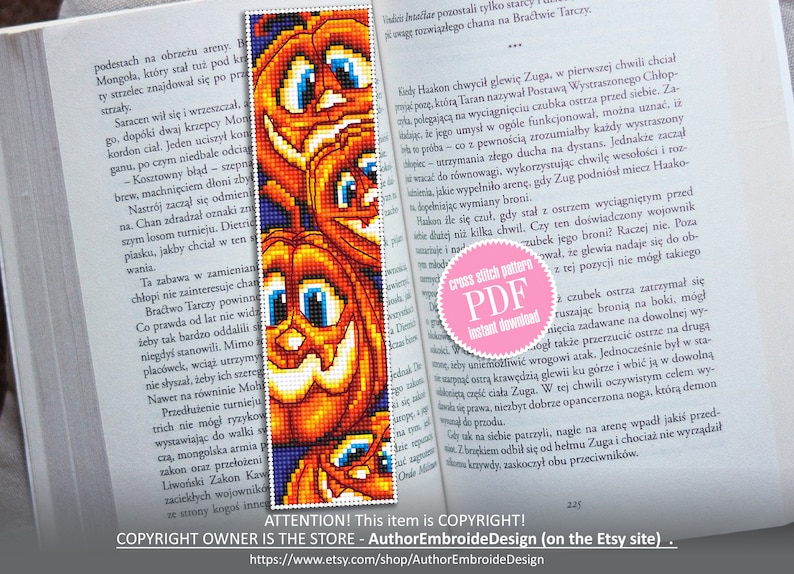 May include: A cross stitch pattern PDF for a bookmark featuring three orange pumpkins with black stems and smiling faces. The pumpkins are against a dark blue background. The text "cross stitch pattern PDF instant download" is on a pink circle.