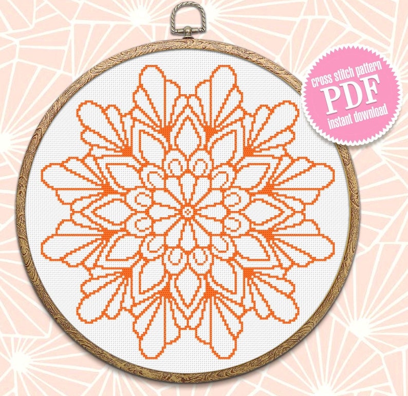 May include: Orange and white cross stitch pattern of a mandala design in a wooden embroidery hoop. The pattern is labelled "cross stitch pattern PDF instant download".