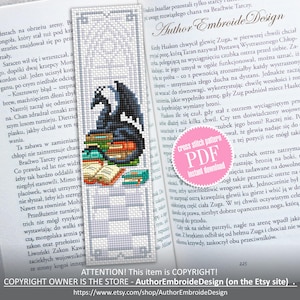 May include: Cross stitch bookmark showing a black dragon on a pile of books. The bookmark has a decorative border and is placed in an open book. The design includes the text "Author EmbroideDesign".