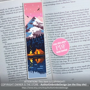 May include: A pink and blue cross stitch pattern bookmark featuring a mountain range with a campfire and a tent in the foreground. The bookmark has the text "cross stitch pattern PDF instant download" in a pink circle.