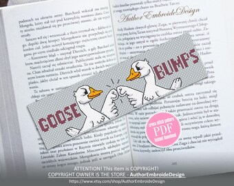 May include: A gray bookmark with the words "GOOSE" and "BUMPS" in maroon, featuring cartoon geese bumping fists. The bookmark is set against the backdrop of an open book.
