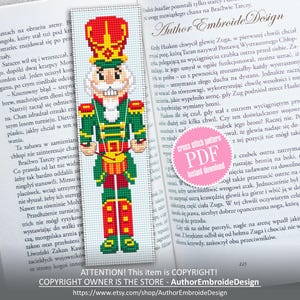 May include: A cross-stitch bookmark featuring a nutcracker soldier in a green uniform with red accents. The bookmark is a pixelated design, with the text "ATTENTION! This item is COPYRIGHT!" at the bottom.