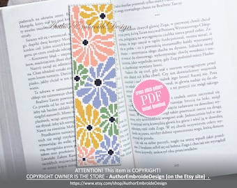 May include: A cross stitch bookmark pattern featuring four colourful flowers with black centres. The bookmark is a PDF instant download. The text "cross stitch pattern PDF instant download" is in a pink circle.
