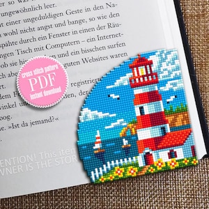 May include: A cross stitch pattern of a lighthouse with a red and white striped tower, a white fence, and yellow flowers. The lighthouse is on a cliff overlooking a blue ocean with white clouds in the sky. The pattern is available as a PDF instant download.