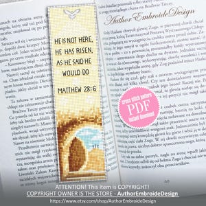 May include: A cross-stitch bookmark with the text "HE IS NOT HERE, HE HAS RISEN, AS HE SAID HE WOULD DO, MATTHEW 28:6." The bookmark features a dove and an image of an empty tomb. The bookmark is on an open book.