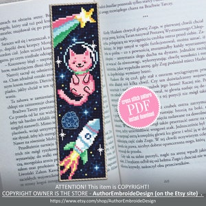 May include: A cross stitch pattern featuring a pink cat wearing a space helmet and a rocket ship flying through space. The pattern is on a black background with a rainbow shooting star. The text "cross stitch pattern PDF instant download" is on a pink circle.
