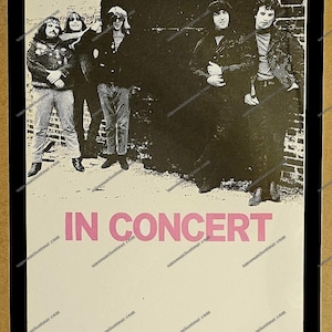 May include: A vintage concert poster featuring the band Grateful Dead. The band's name is in large pink letters at the top, with the words "IN CONCERT" below. The poster has a black border and features a photo of the band members.