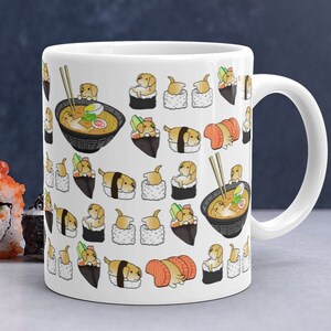 May include: White ceramic mug with a pattern of cartoon dogs dressed as sushi and ramen. The dogs are in various poses, including sitting, standing, and eating. The mug has a black handle.