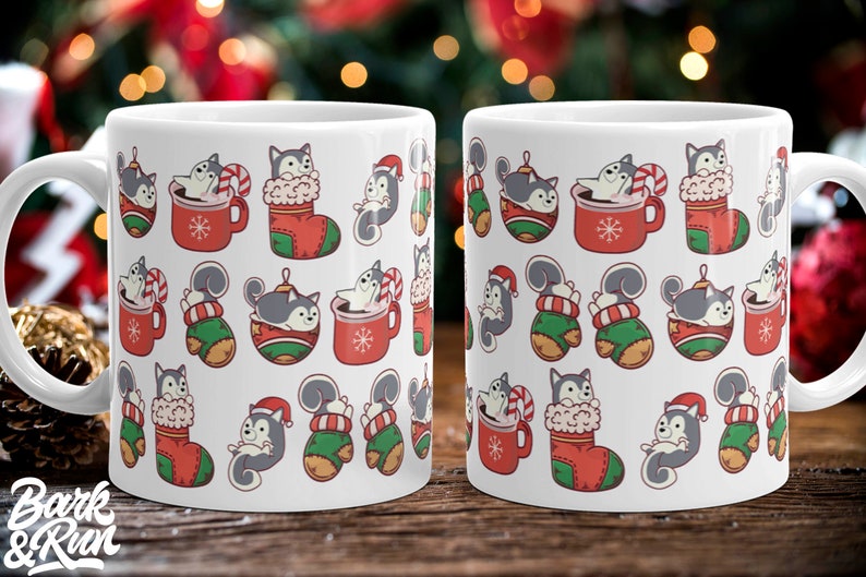 May include: White ceramic mug with a Christmas-themed design featuring a repeating pattern of cartoon huskies in red and green stockings, red mugs, and green mittens. The huskies are wearing Santa hats and holding candy canes.