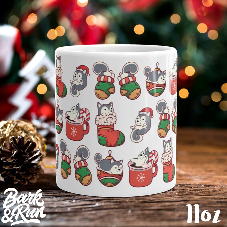 May include: White ceramic mug with a Christmas pattern featuring cartoon huskies in various poses, including wearing Santa hats, holding candy canes, and sitting in stockings. The mug has a 11oz capacity.