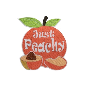 May include: Embroidered iron-on patch with a peach design. The peach is orange with a white stem and green leaves. The peach has the words "Just Peachy" written on it in white.