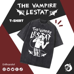 May include: Dark grey t-shirt with the text "THE VAMPIRE LESTAT" and an illustration of a man singing. The shirt includes the text "ON TOUR" and bat wing graphics. The word "T-SHIRT" is also visible on the shirt.