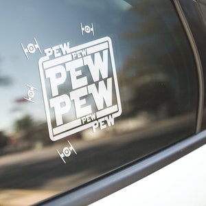May include: A white car window sticker with the word "PEW" repeated four times in a square. The sticker is surrounded by four small white images of the Star Wars X-Wing fighter.
