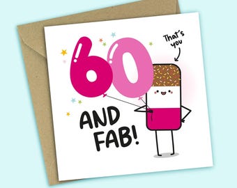 May include: A square greeting card featuring a cartoon ice cream bar holding two pink balloons shaped like the number 60. The text reads 60 AND FAB! with an arrow pointing to the ice cream bar labelled That's you. Includes a brown envelope.