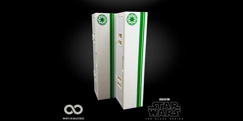 May include: Two white rectangular boxes with green stripes and circular logos, likely for Star Wars collectibles. The boxes have a series of small rectangular cutouts. The words "SCALED FOR STAR WARS THE BLACK SERIES" are printed on the bottom right.