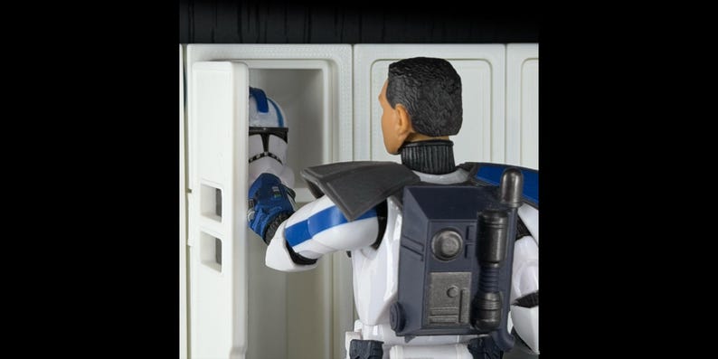 May include: A figure in a white and blue uniform with a black backpack and a helmet. The figure is opening a white cabinet to reveal a matching helmet. The scene is set against a black background.