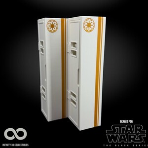 May include: Two white and gold Star Wars themed lockers. Each locker has a gold stripe down the side and a gold emblem on the top. The text "SCALED FOR STAR WARS THE BLACK SERIES" is visible.