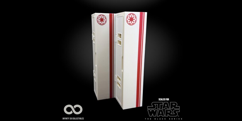 May include: Two white rectangular Star Wars display cases with red stripes and Imperial symbols. The cases have small rectangular cutouts and are set against a black background. The text "SCALED FOR STAR WARS THE BLACK SERIES" is visible.