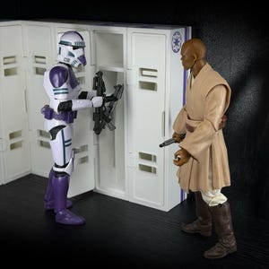 May include: Two action figures from the Star Wars franchise. One figure is a white and purple Stormtrooper, the other is a Jedi in a tan robe. The Stormtrooper is holding a weapon near a white locker.