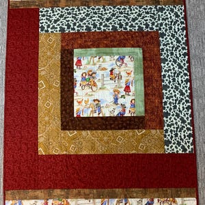 May include: A red, brown, green, and white patchwork quilt with a square pattern. The quilt features a repeating pattern of children riding tricycles and playing with farm animals.