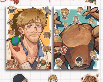 May include: Two rectangular art prints labeled 5x7 and 7x10 featuring anime-style illustrations of a man with brown hair and glasses, a large brown rock-like creature, and various small character stickers including a crab-like figure and text.