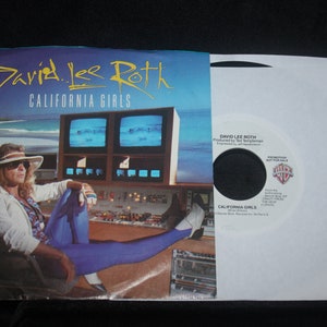 May include: A vinyl record cover featuring David Lee Roth with the title "California Girls". The cover art shows Roth sitting in a chair with a surfboard behind him, wearing a white hat and blue pants. The record label is white with black text and a Warner Bros. Records logo.