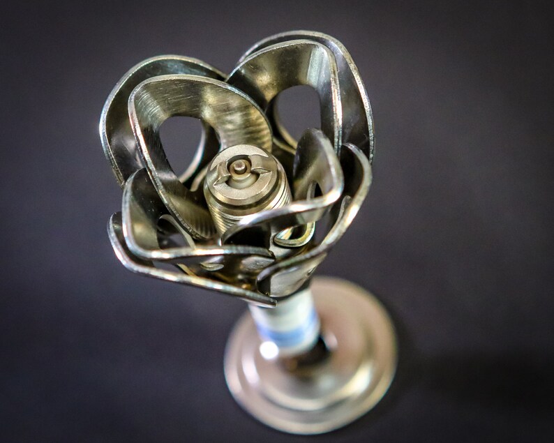 One spark plug rose on black background