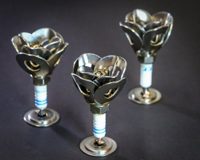 Three spark plug roses with black backdrop