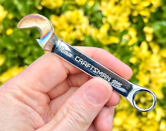 May include: A silver Craftsman wrench with a bottle opener on one end. The wrench is 1/4 inch.