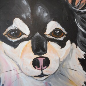May include: A close-up painting of a black and white dog's face. The dog has brown eyes, a black nose, and a pink tongue. The painting is done in a realistic style.
