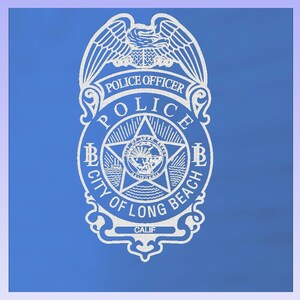 May include: A white police badge with the words "POLICE OFFICER" and "POLICE" at the top. The badge has a star in the center with the words "CITY OF LONG BEACH CALIF" around the bottom. The badge is on a blue background.