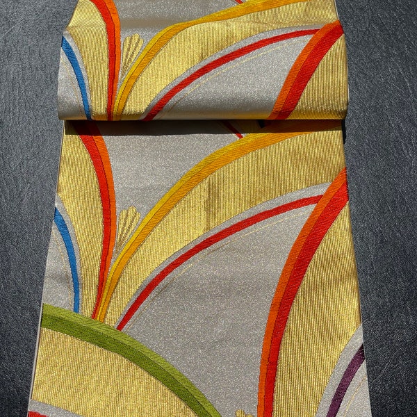 Japanese obi/kimono sash, metallic silver background with gold and rainbow-coloured arabesques; pristine cond, unworn