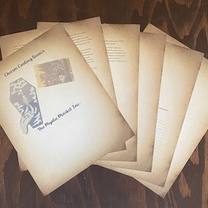 May include: A stack of blank, cream-colored paper with a title that reads "Charm Casting Basics" and a logo that says "The Mystic Market Inc.".