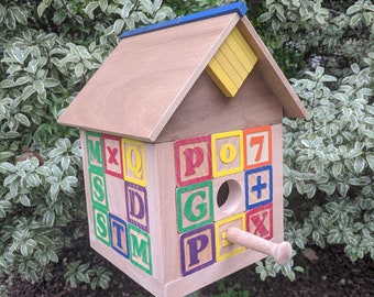 Birdhouse made of children&#39;s ABC blocks