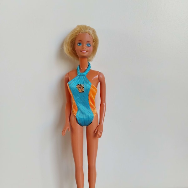 Vintage Barbie with short blonde hair in a swimsuit from the 80s/90s Mattel