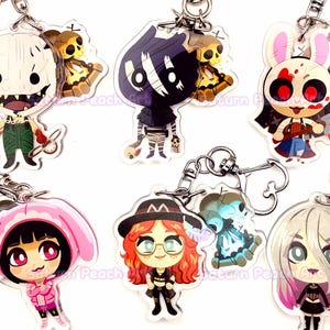 May include: A collection of six acrylic keychains featuring stylized cartoon characters, each paired with a smaller secondary charm. The designs include various figures with distinct outfits, hair colors, and accessories, all attached to silver metal clasps.
