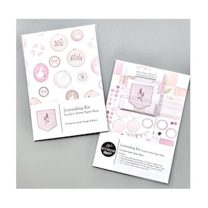 May include: Two journaling kits by Jojo's Pretty Paper Shop. The kits feature a patchwork quilt design with pink and white elements. One kit includes a mini paper pack and journaling pockets. The packaging displays floral and decorative designs.