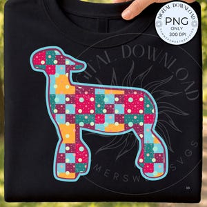 May include: A black t-shirt featuring a graphic of a lamb silhouette filled with a colourful patchwork pattern of squares in shades of pink, teal, and yellow, accented with small white polka dots and a light blue outline around the lamb shape.