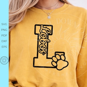 May include: A mustard yellow crewneck sweatshirt featuring a large black block letter L with the word Lobos written in a cursive script inside the vertical bar and a black paw print graphic attached to the bottom right corner of the letter.