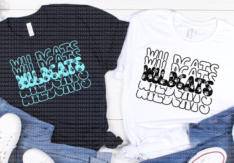 May include: A black t-shirt and a white t-shirt, each featuring a repeating stacked graphic of the word WILDCATS in a wavy font. The black shirt has a bright cyan print, while the white shirt has a black print with small paw print accents.