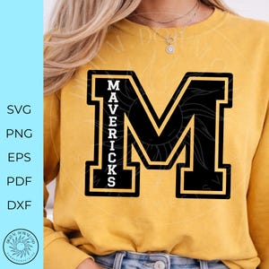 May include: A mustard yellow crewneck sweatshirt featuring a large black varsity-style letter M with a gold outline. The word MAVERICKS is printed vertically in white block letters inside the left side of the letter M. The text SVG PNG EPS PDF DXF is visible.