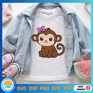 May include: White t-shirt featuring a cartoon monkey with a pink bow. The monkey is brown with large eyes and a smiling expression. The shirt is displayed on a light blue denim jacket, with pink shoes and a watermelon-shaped item in the background. The image also includes text: SVG, DXF, PNG, EPS, PDF.