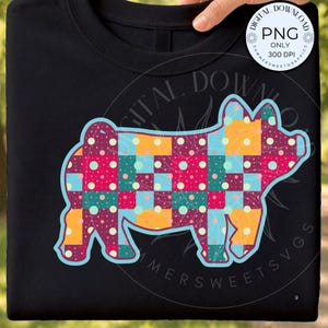 May include: A black t-shirt featuring a graphic of a pig silhouette filled with a colourful patchwork pattern of squares in shades of pink, teal, yellow, and purple, each decorated with small white polka dots and outlined in a light blue border.