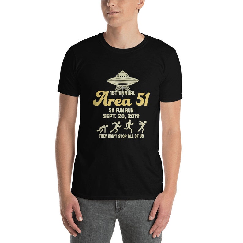 May include: Black t-shirt with a graphic of a UFO and the text "1st Annual Area 51 5K Fun Run Sept. 20, 2019 They Can't Stop All of Us".