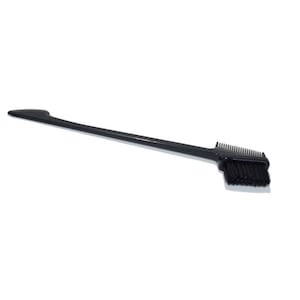 May include: A black dual-ended styling tool with a comb and brush. The handle is long and slender, leading to a rectangular head with a comb on one side and a brush on the other. The bristles are black.