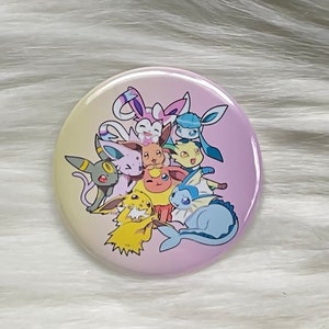 May include: A round button featuring a group of colorful cartoon characters. The button has a gradient background of yellow, pink, and purple. The characters are various colors, including yellow, blue, pink, and gray.